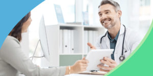 doctor and patient smiling with clipboard
