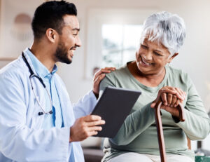 Shot of a young doctor sharing information from his digital tablet with an older patient.