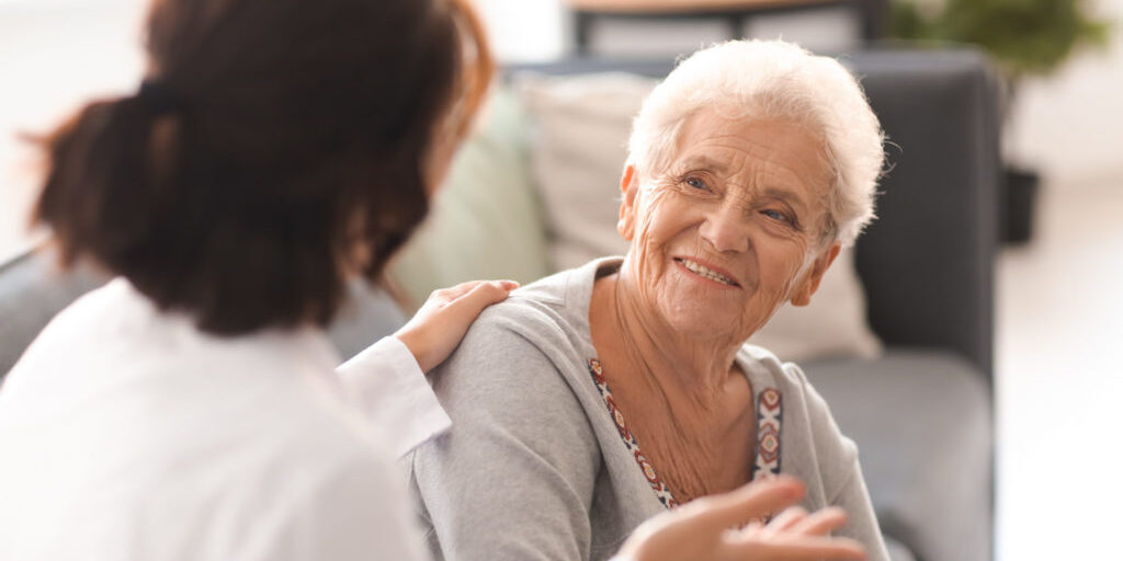 Elderly Medicare patient smiling with clinician