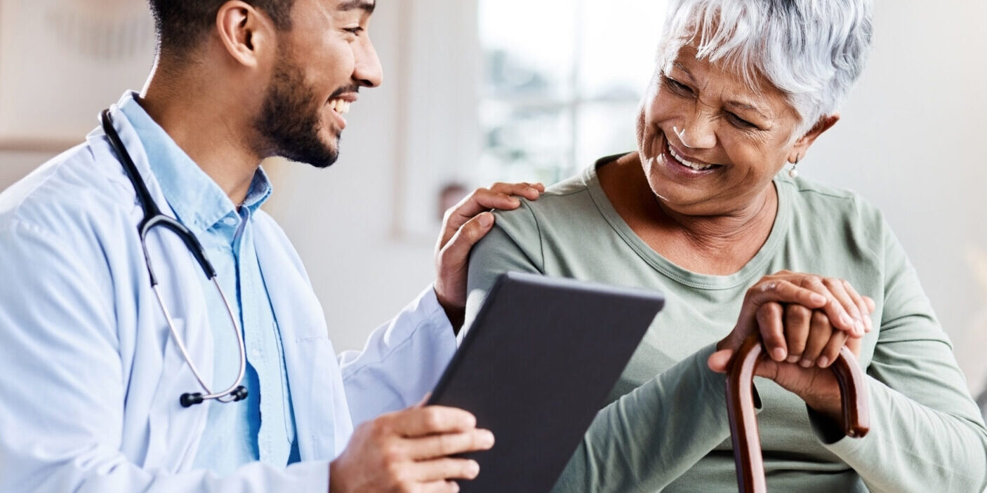 Shot of a young doctor sharing information from his digital tablet with an older patient.