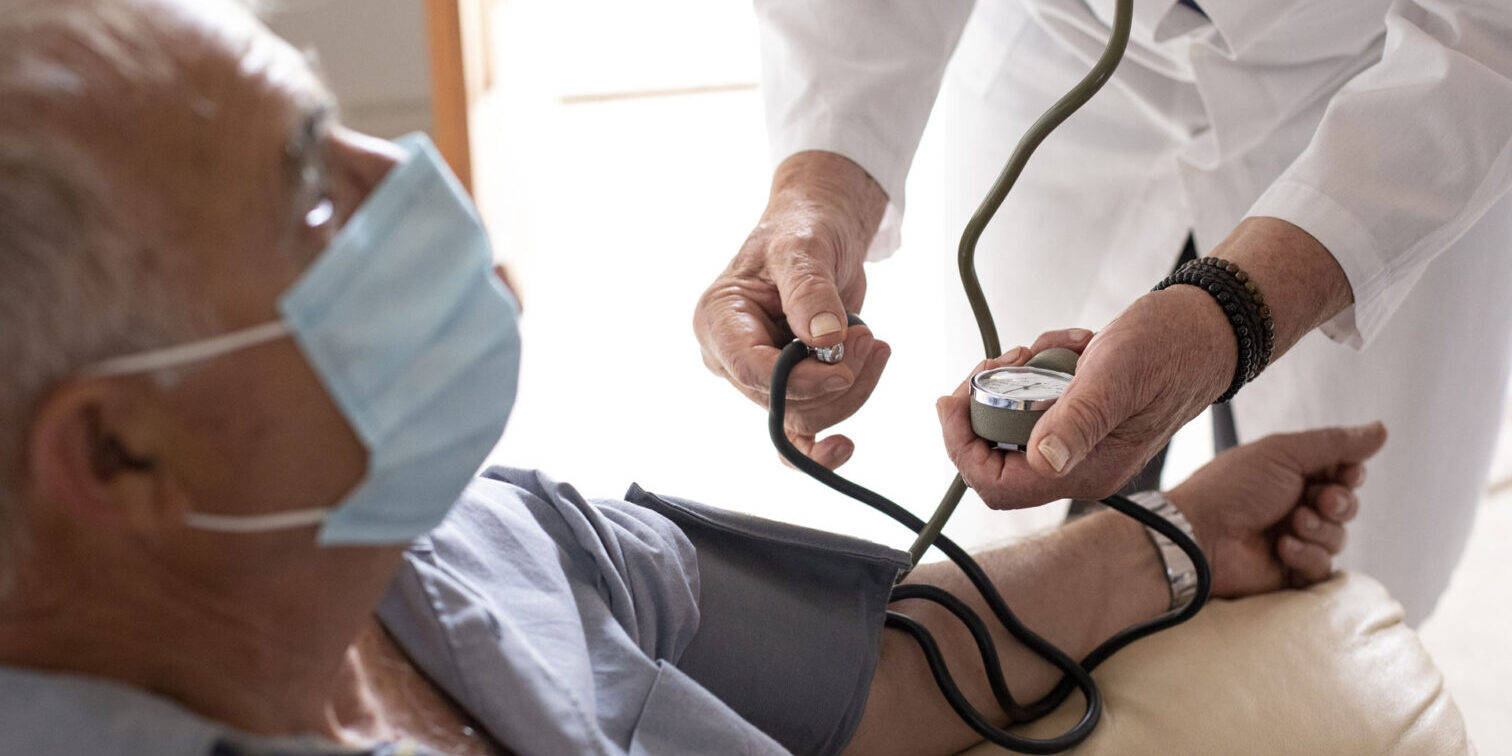 Elderly patient getting blood pressure taken